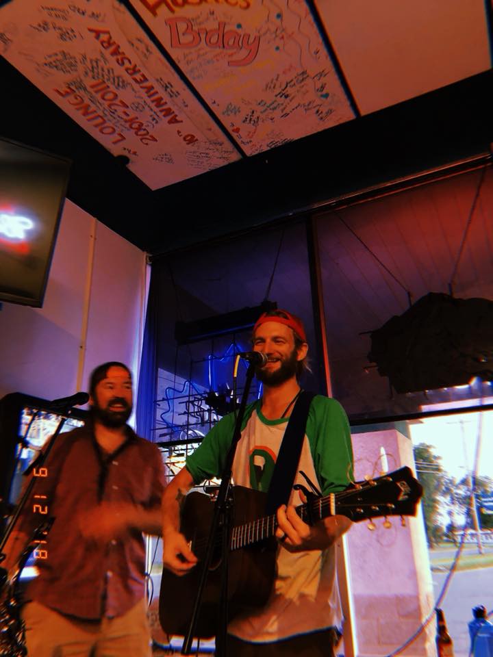 Duo performing beneath a signed ceiling